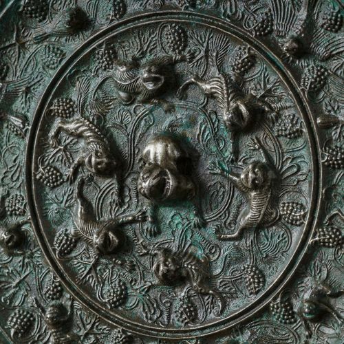 A LARGE CIRCULAR BRONZE 'LION AND GRAPEVINE' MIRROR 大型环形铜制 "狮子和葡萄藤 "镜
中国，清朝末年。 这&hellip;