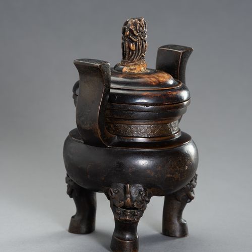 A HEAVILY CAST BRONZE TRIPOD CENSER 一个重铸的青铜鼎炉
中国，明朝末年（1368-1644）。罐子有一个压扁的球状体，三条腿&hellip;