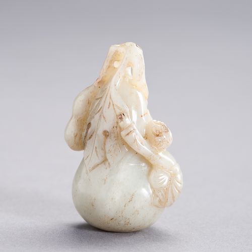 A CELADON JADE PENDANT DEPICTING A BOY CLIMBING A GIANT DOUBLE GOURD, LATE QING &hellip;