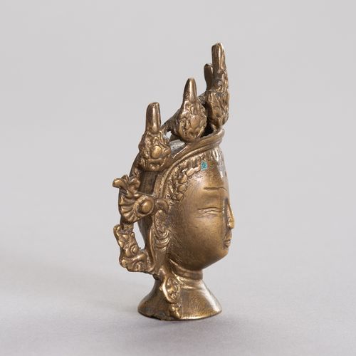 A MINIATURE BRONZE HEAD OF BODHISATTVA 小型铜质菩萨头像
西藏，17至18世纪。青铜菩萨头像有明显的镀金痕迹。精心铸造的五&hellip;