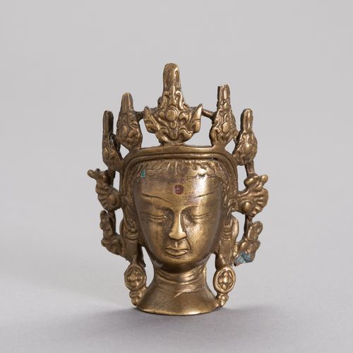 A MINIATURE BRONZE HEAD OF BODHISATTVA 小型铜质菩萨头像
西藏，17至18世纪。青铜菩萨头像有明显的镀金痕迹。精心铸造的五&hellip;
