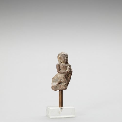 AN INDIAN RED SANDSTONE FRAGMENT DEPICTING A FEMALE WORSHIPPER AN INDIAN RED SAN&hellip;