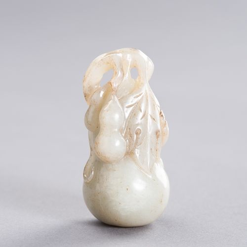 A CELADON JADE PENDANT DEPICTING A BOY CLIMBING A GIANT DOUBLE GOURD, LATE QING &hellip;