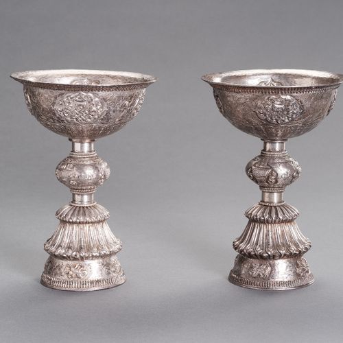 A LARGE PAIR OF SILVER BUTTER LAMPS A LARGE PAIR OF SILVER BUTTER LAMPS
Tibetan-&hellip;
