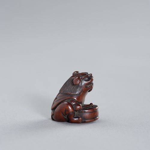 TAMETAKA: A NAGOYA SCHOOL WOOD NETSUKE OF A BOY WITH SHISHIMAI COSTUME TAMETAKA:&hellip;