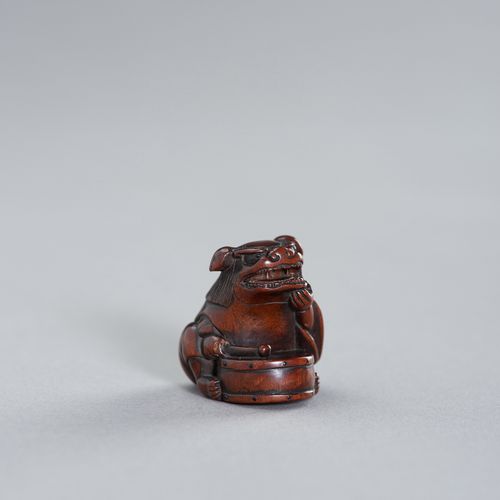 TAMETAKA: A NAGOYA SCHOOL WOOD NETSUKE OF A BOY WITH SHISHIMAI COSTUME TAMETAKA &hellip;