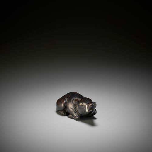 A LARGE AND OLD DARK WOOD NETSUKE OF A RECUMBENT BOAR A LARGE AND OLD DARK WOOD &hellip;