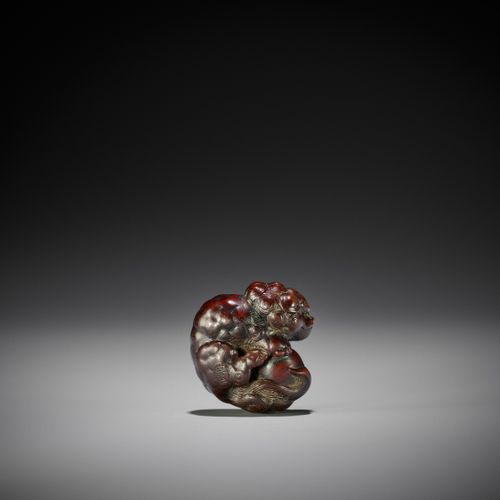 TOYOKAZU: A FINE WOOD NETSUKE OF A SHISHI PLAYING WITH A BALL TOYOKAZU: A FINE W&hellip;