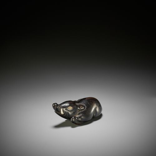 A LARGE AND OLD DARK WOOD NETSUKE OF A RECUMBENT BOAR A LARGE AND OLD DARK WOOD &hellip;