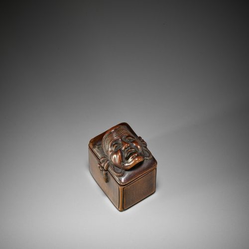 AN UNUSUAL WOOD NETSUKE OF A BUNRAKU WITHIN A MASK STORAGE BOX Japan, 19th centu&hellip;