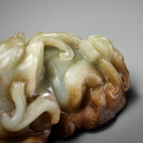 A CELADON AND RUSSET JADE 'BUDDHIST LION AND CUB' GROUP, 17TH CENTURY BUDDHISTIS&hellip;