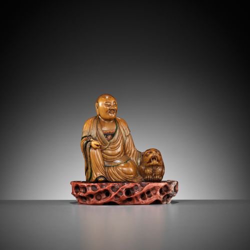 A SOAPSTONE FIGURE OF A LUOHAN WITH A BUDDHIST LION, 18TH CENTURY SEIFSTEINFIGUR&hellip;