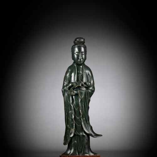 A LARGE AND MASSIVE SPINACH-GREEN KHOTAN JADE FIGURE OF GUANYIN, PROBABLY TAKEN &hellip;