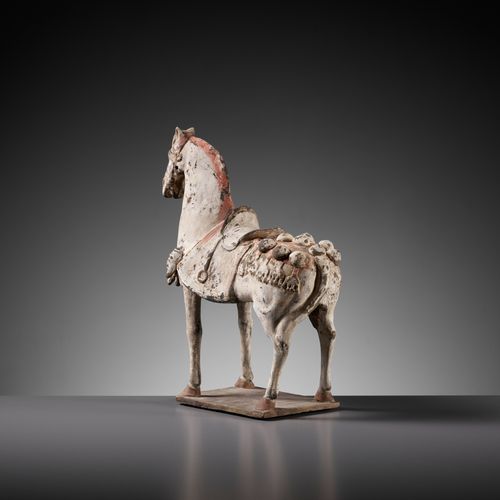 A PAINTED POTTERY FIGURE OF A CAPARISONED HORSE, EASTERN WEI DYNASTY BEMALTE KAP&hellip;