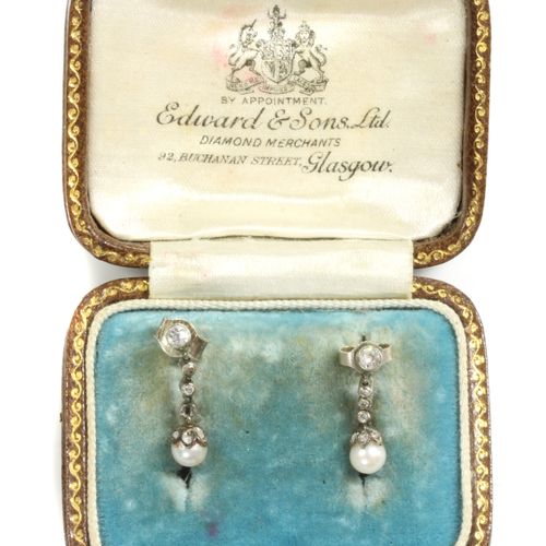 Null A cased pair of early 20th century pearl and diamond drop earrings,