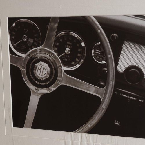 GROUP OF THREE AUTOMOBILE RELATED PRINTS 三幅与汽车有关的画作，每幅画都有一个黑色的框架。