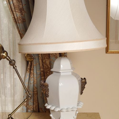 PAIR OF PORCELAIN TABLE LAMPS and shades, each with a vase-shaped stem, moulded &hellip;