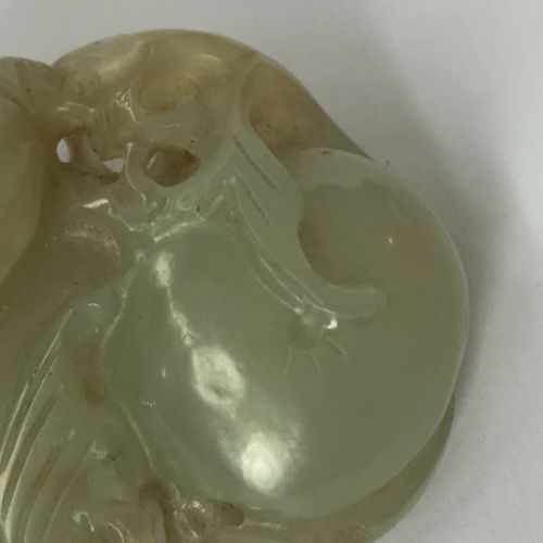 Null A Chinese celadon jade 'lingzhi' pendant and a coral horse, 19th century, t&hellip;