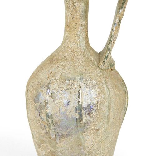 Null A Roman clear glass ewer, circa 1st-2nd century AD., the base with indented&hellip;