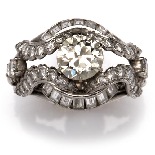 A 14k white gold diamond dress ring 14K白金钻石戒指，正面镶嵌着一颗老式切割钻石，重约1.2克拉，与长方形和明亮式切割钻石&hellip;