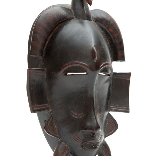 A Senufo face mask, keplié 一个Senufo面罩，keplié，20世纪，象牙海岸，向下的角有黑色条纹，顶部是一个鸟头。高26.5厘米&hellip;