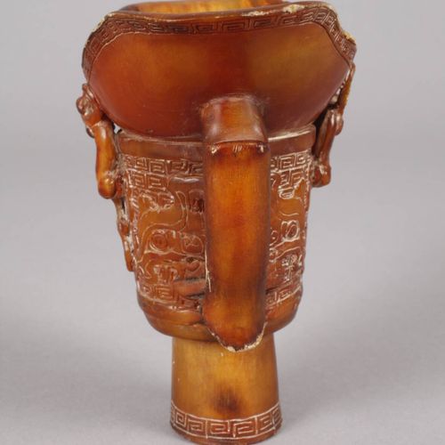 Null 
Horncup
China, c. 1900, unsigned, an elaborately carved footed cup of ambe&hellip;