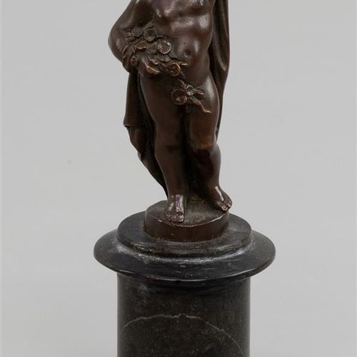 Null A bronze statuette of a youth with flower branch and drapery, black stone b&hellip;