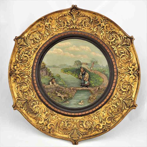 Large ornamental plate, around 1880 大型装饰盘，约1880年

陶瓷的浮雕工艺。表现风景，有房屋、人和动物。宽大的金色边框，&hellip;