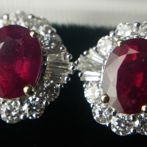 Null A PAIR OF 18CT WHITE GOLD, OVAL CUT TREATED RUBIES AND DIAMOND CLUSTER STUD&hellip;