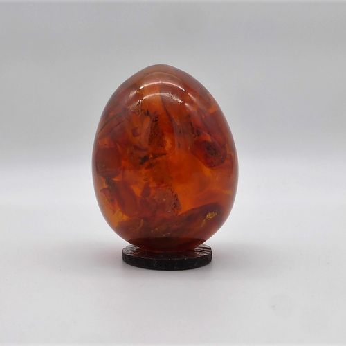 Null Amber egg, amber with inclusions, h. 5,5cm, 77g. (273-36)