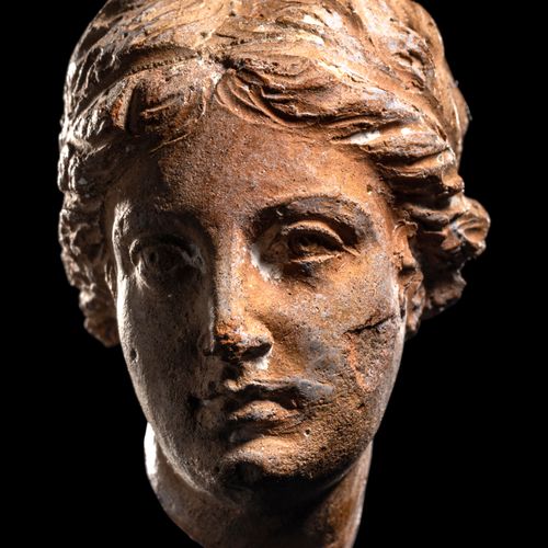 Null A Greek Terracotta Female Head

Height 1 9/16 inches (4 cm).