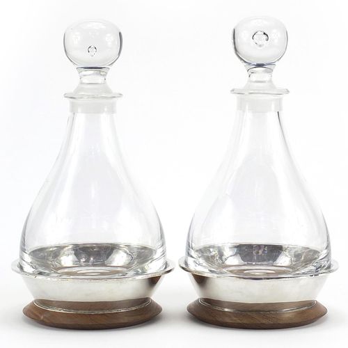 Null Pair of cut glass decanters with silver mounted oak stands by Simon J Beer &hellip;