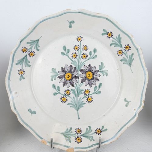 Null FOUR earthenware plates enameled with polychrome flowers. 19th century. Dia&hellip;