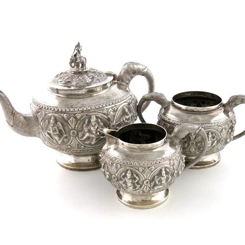 Null A three-piece Indian silver tea set, unmarked, circular bellied form, embos&hellip;