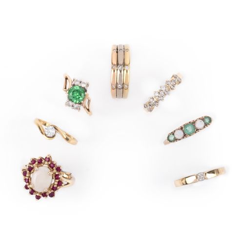 Null A group of seven gold and gem-set rings, comprising: an opal and ruby clust&hellip;