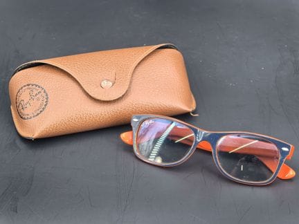 Ray-Ban, a pair of sunglasses, black and orange