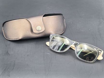 Ray-Ban, a pair of sunglasses, black and white.
De