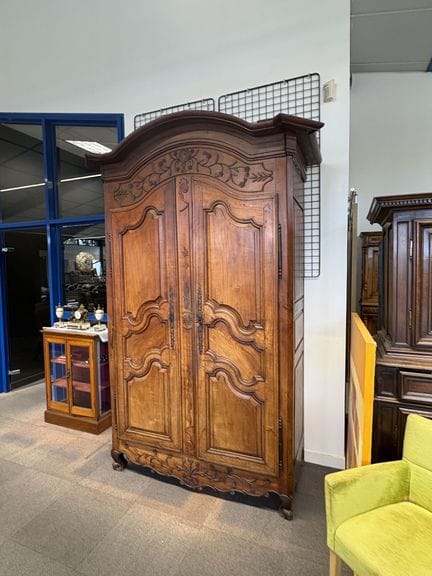 Wooden cabinet with molded and carved trim, featur