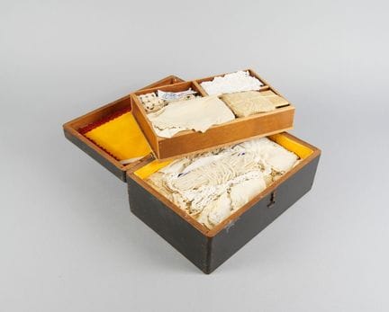 Wooden box containing lace and miscellaneous items