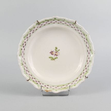 SOUTHWEST
Glazed earthenware plate with a scallope