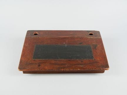 Natural wood writing desk with a drop-down lid.
H.