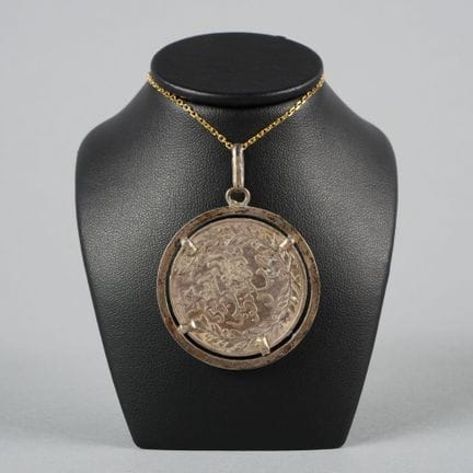 Pendant set with a Moroccan silver coin, minted in