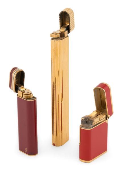 Deux briquets Cartier et un briquet Dupont. En bon