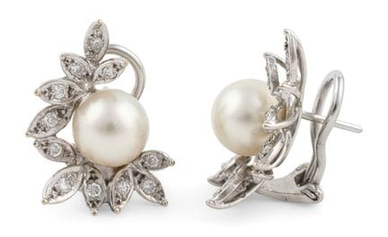 A pair of 750 white gold ear clips, each featuring