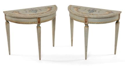 A pair of demi-lune console tables, carved and pai