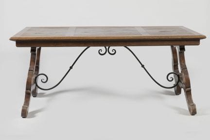 Dining table with an oak top, resting on a lyre-sh
