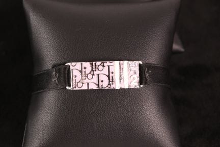 DIOR - Bracelet ruban en métal argenté centré d'un