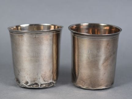 TWO plain silver timbales, with rims accented by f