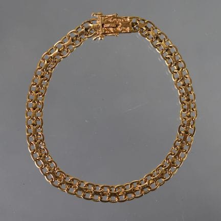 BRACELET souple en or jaune à mailles entrelacées,