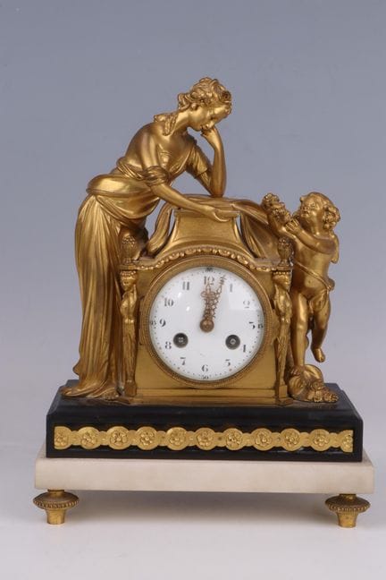 OROLOGIO in bronzo dorato e cesellato, detto “Il r